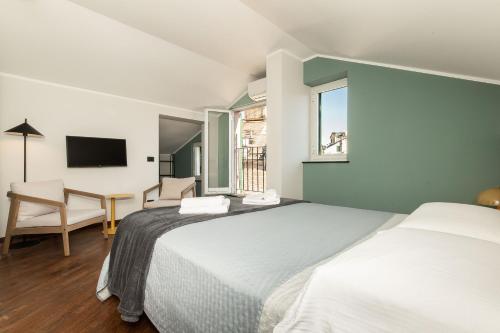 a bedroom with two beds and a desk and a window at Genova Suite Art in Genoa