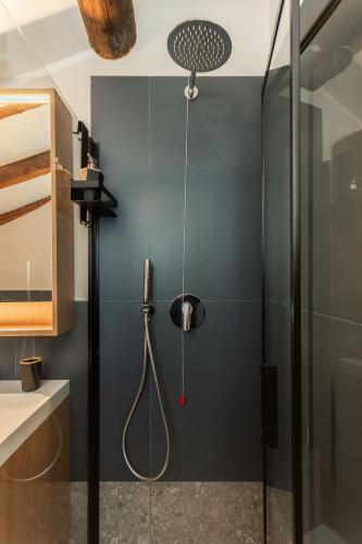 a bathroom with a shower with a shower head at Genova Suite Art in Genoa