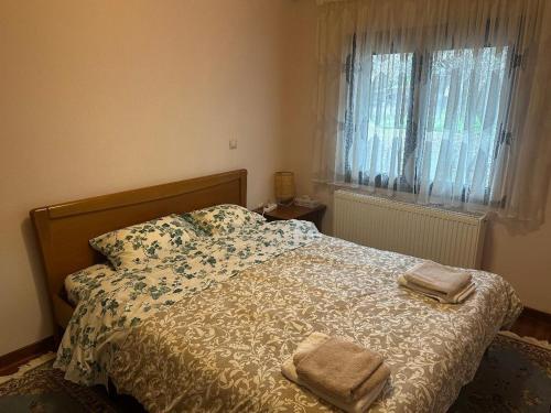 a bedroom with a bed with two towels on it at Stymfalia Cozy Village Guesthouse in Kartérion
