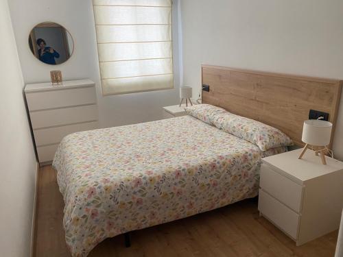 a bedroom with a bed and a mirror at Casa As Estelas Camino de santiago por la costa Playa America in Nigrán