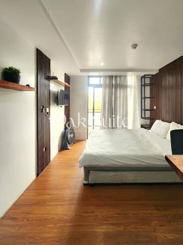 a bedroom with a large bed and a window at Oak Suite in Baguio