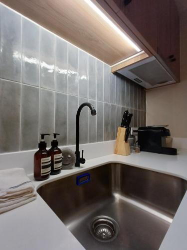 a kitchen counter with a sink and a sink at The Florentine Suite in Manila