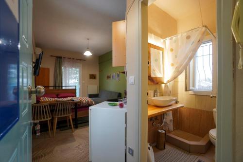 a kitchen with a white refrigerator in a room at Marianna's studio in Kozani