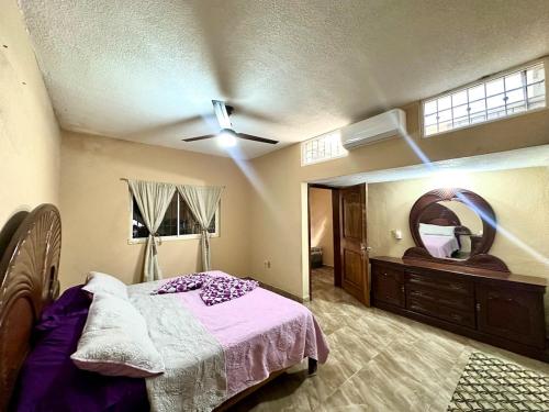 a bedroom with a bed and a ceiling fan at Colimota in Colima