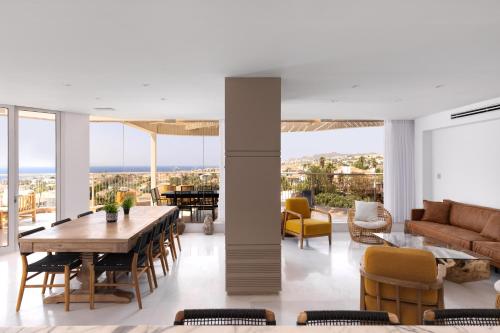 a living room with a table and chairs at Kedem Eilat קדם אילת in Eilat