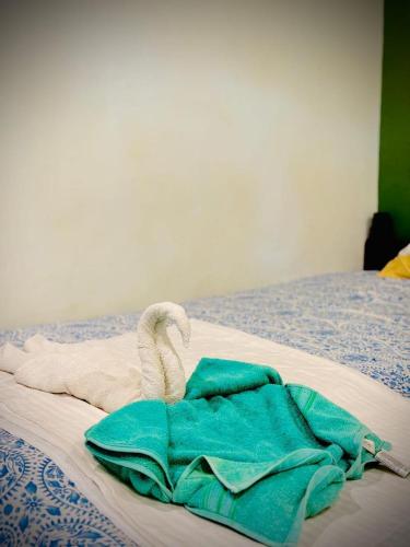 a bed with a towel and a swan on it at Greenbay Beach Resort in Varkala