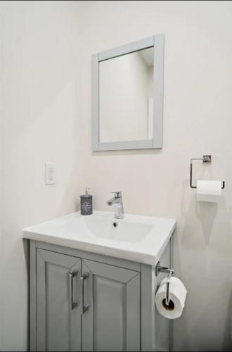 a bathroom with a sink and a mirror at Cozy stays in Montréal