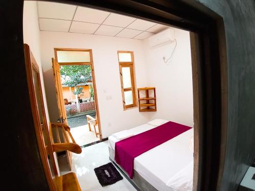 a view of a bedroom with a bed and a window at Diamond Resorts in Udawalawe