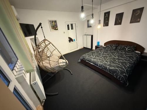 a bedroom with a bed and a swing at Kara Apartaments in Ploieşti
