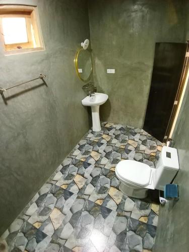 a bathroom with a toilet and a sink at Diamond Resorts in Udawalawe