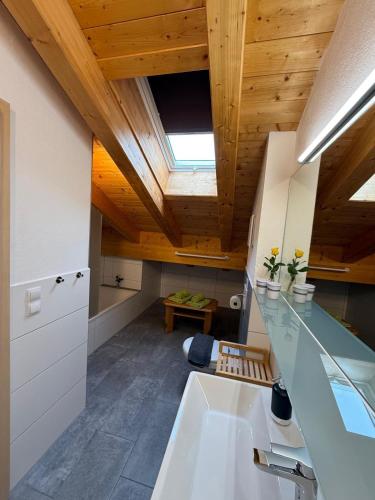 a kitchen with a sink and a wooden ceiling at Haus Lagger in Seefeld in Tirol
