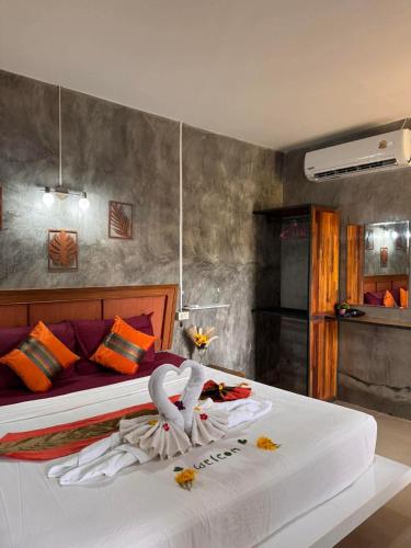 a hotel room with a bed with a towel on it at Lanta natural hut garden in Ko Lanta