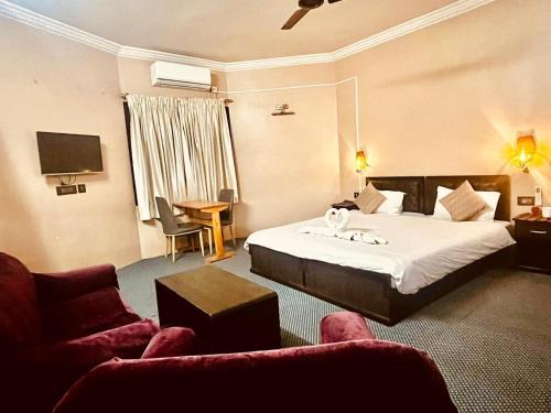 a hotel room with a bed and a couch at Rinchen Hotel in Kathmandu