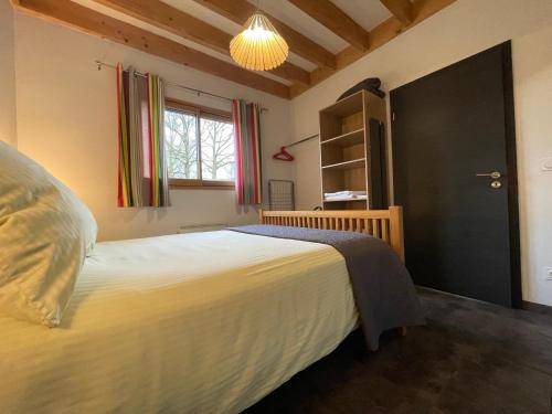 a bedroom with a large bed and a window at Appartement Plein Pied Arrow Wood La Flèche in La Flèche