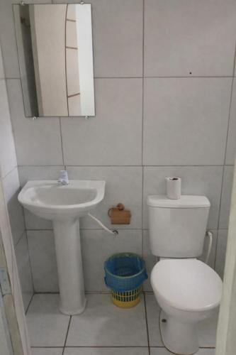 a small bathroom with a toilet and a sink at Mutary II in Santa Cruz Cabrália