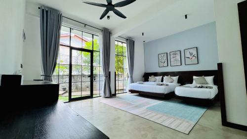 a bedroom with two beds and a large window at Humble Ella in Ella