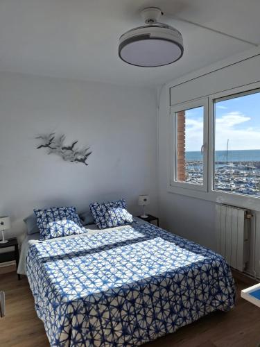 a bedroom with a bed and a large window at Candela's Beach Port in El Masnou