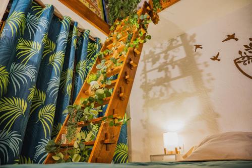 a room with a ladder with plants on the wall at La Suite de Richarville in Richarville