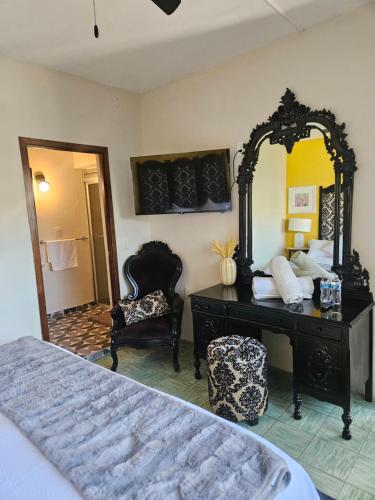a bedroom with a dresser and a mirror and a bed at Casa Mestiza in Guadalajara