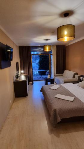 a large hotel room with two beds and a couch at Bešeňová Apartment in Bešeňová