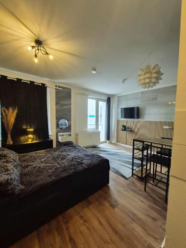 a bedroom with a bed and a dining room at Onyx Urban Suite in Hannover