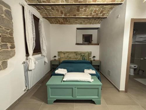 a bedroom with a blue bed in a room at Lo Shangrilá B&B in Borrello