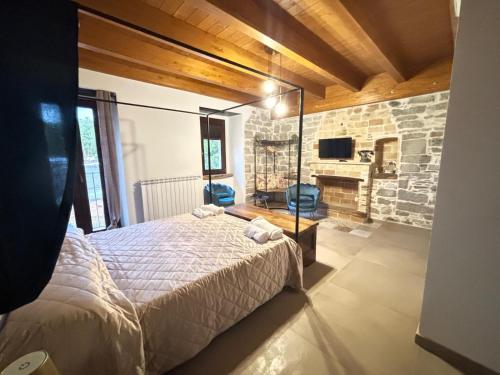 a bedroom with a bed and a stone wall at Lo Shangrilá B&B in Borrello