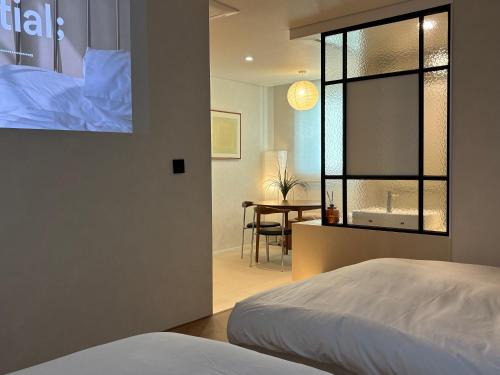 a bedroom with a bed and a table in a room at 무무 mumu in Seoul