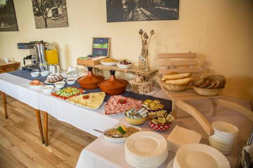 a table with a buffet of food on it at Hotel Sirákov in Liptál