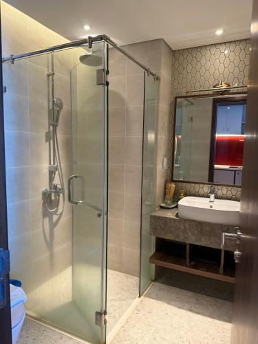 a bathroom with a glass shower and a sink at Apec Mandala Chambay - Dimond Hotel in Ấp Thiẹn Ái