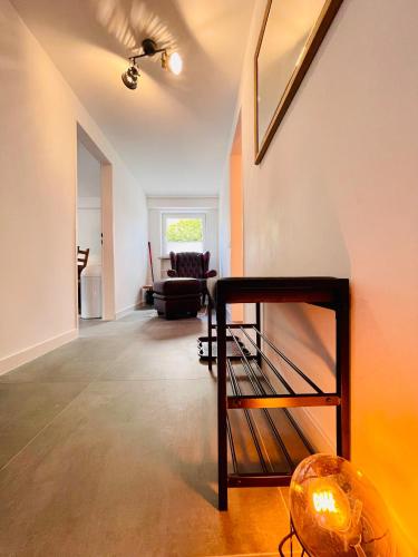 a living room with a staircase in a house at Lichtdurchflutetes Souterrain Apartment in Schapen in Braunschweig