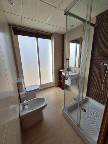 a bathroom with a shower and a toilet and a sink at Apartamento Escobar Plaza in Nerja
