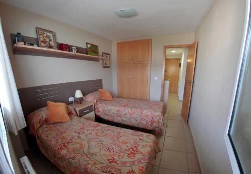 a hotel room with two beds and a hallway at Cullera - Primera Línea de Playa in Faro de Cullera