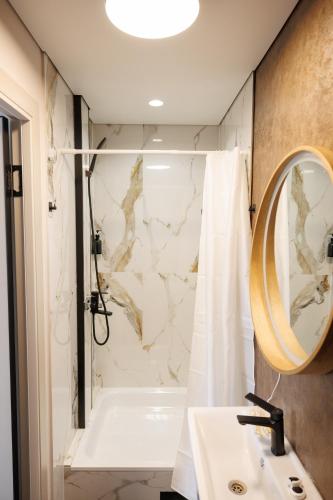 a bathroom with a shower and a sink at GuestHouse-Medeu in Almaty