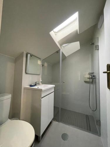 a bathroom with a shower and a toilet and a sink at Easy Stay In Espinho in Espinho