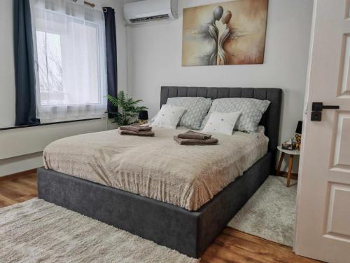 a bedroom with a bed with two towels on it at Horizon Hill in Cserszegtomaj