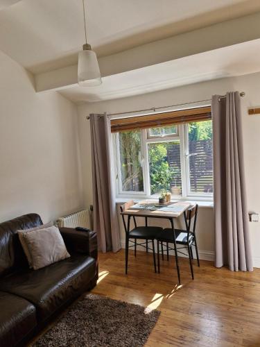 a living room with a table and a couch at Apartment in Solihull, near B'ham, NEC & Warwick in Solihull