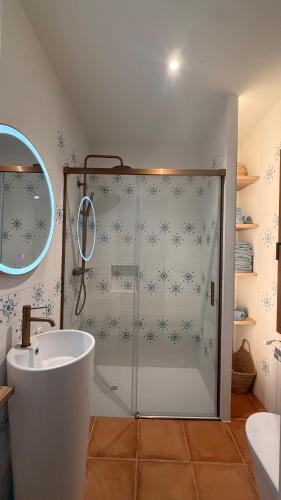 a bathroom with a shower with a tub and a sink at Bellavista in Begur
