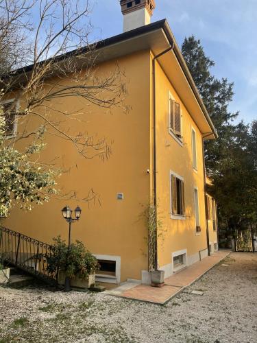 a yellow building with a tower on top at Oasi Gioia verde in Vescia