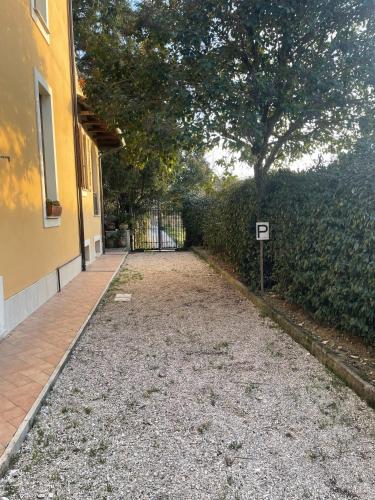 a driveway of a house with a fence and a tree at Oasi Gioia verde in Vescia