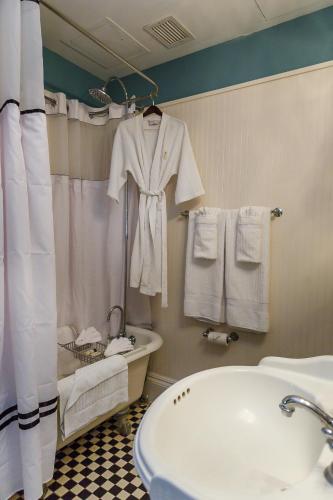 a bathroom with a sink and a tub and towels at The Marshall House, Historic Inns of Savannah Collection in Savannah