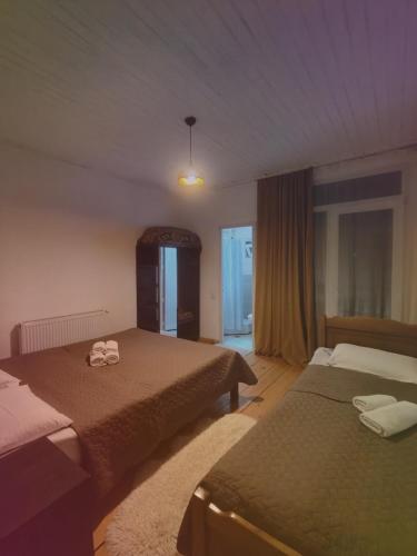 a hotel room with two beds with towels on them at Apartment of mestia in Mestia