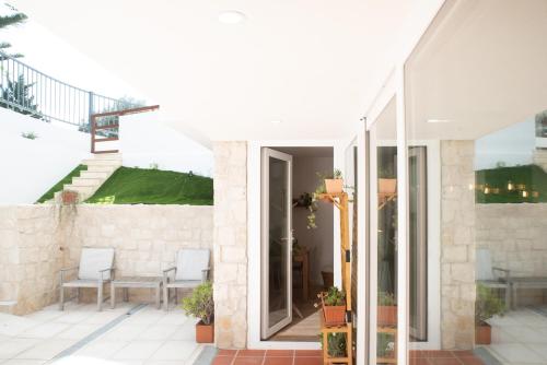 a house with a glass door on a patio at Relax House in Estoril