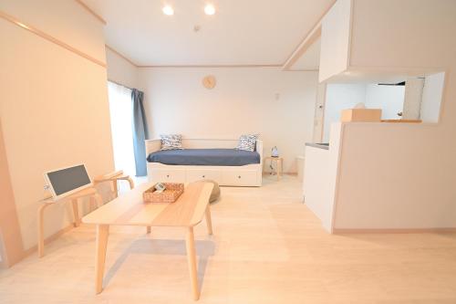 a small room with a bed and a table at Residence Hotel Kamoike in Kagoshima