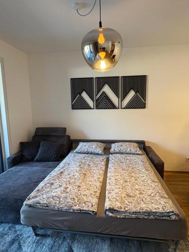 two beds in a room with a couch and a light at Apartment Lisa Hinterstoder in Hinterstoder
