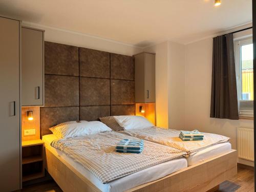 a bedroom with a large bed with two towels on it at Hardthof Sauerland in Schmallenberg