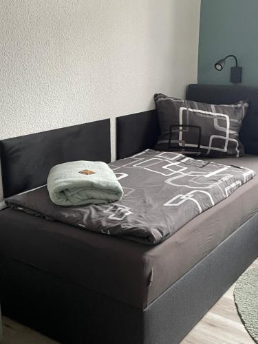 a bed in a room with a black bed frame at FeWo BiBo in Freiberg