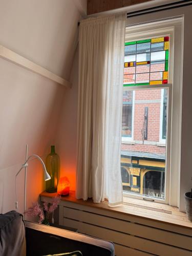 a window with a view of a building at At Loum in Alkmaar