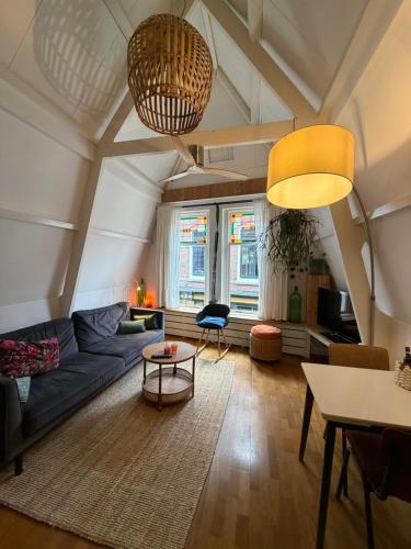 a living room with a blue couch and a table at At Loum in Alkmaar