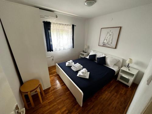 a bedroom with a bed with two dishes on it at Stone house Skrivena in Pridraga